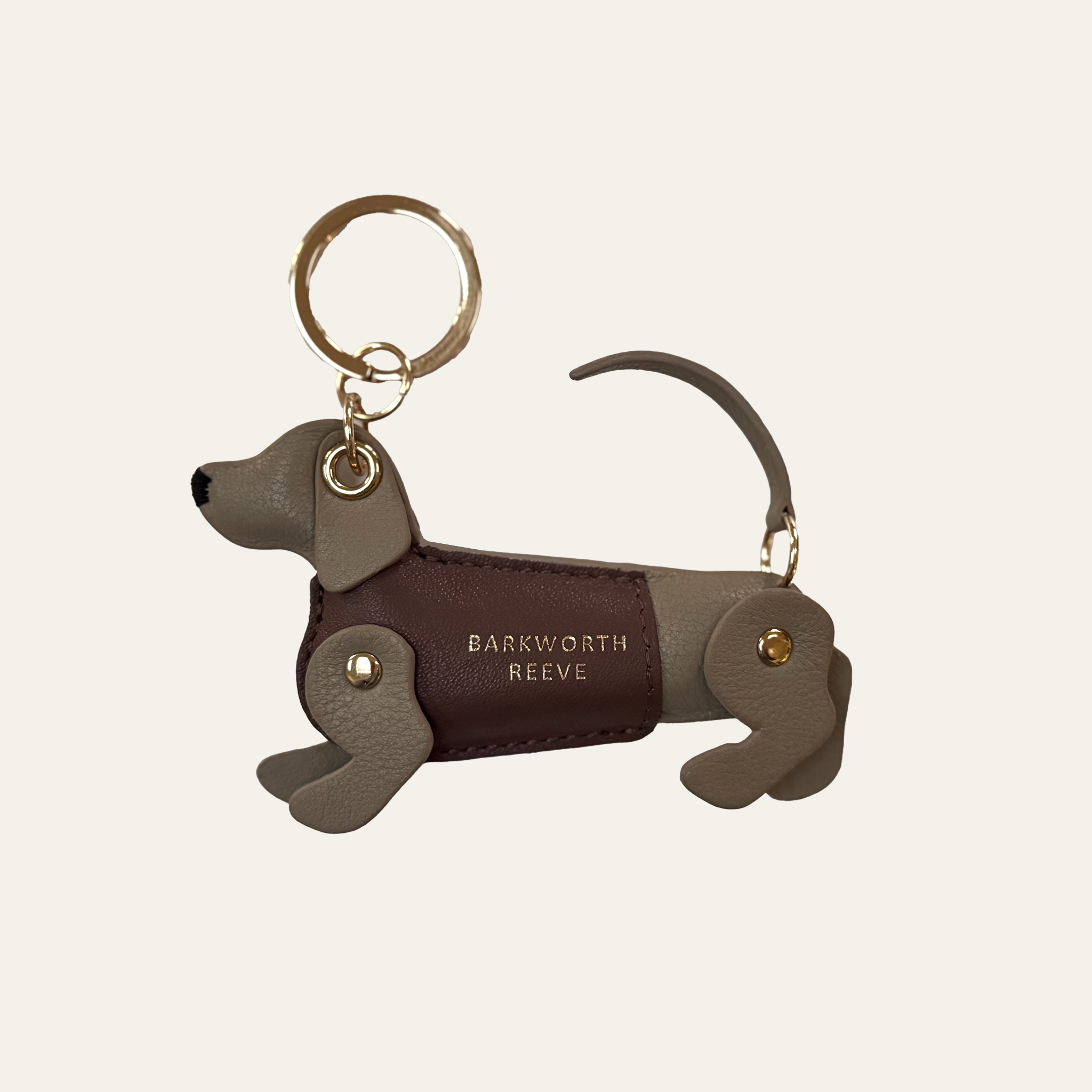 isabella grey leather dachshund keyring, with deep pink leather coat and gold keyring split ring