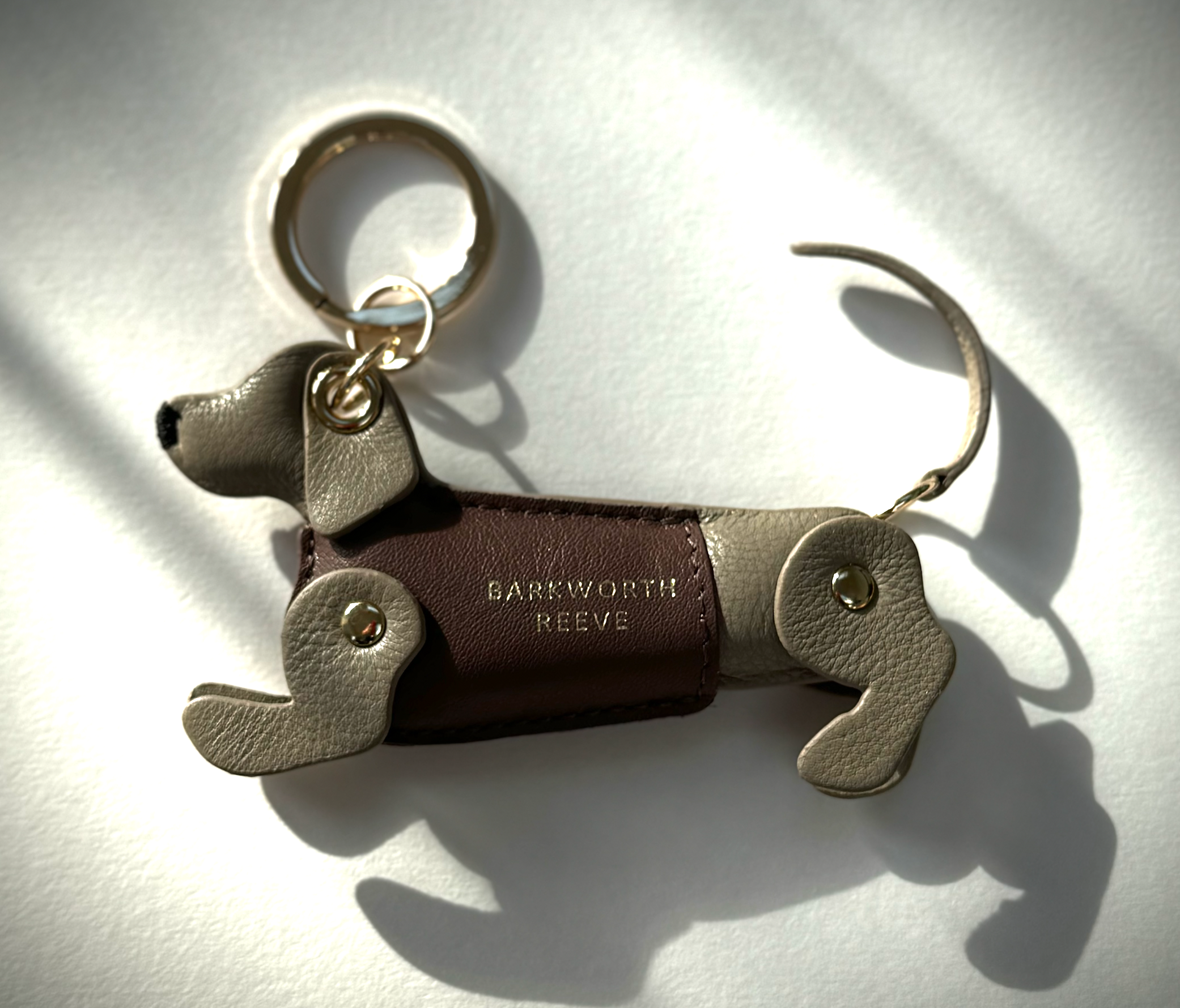 Isabella grey leather dachshund keyring, with deep pink leather coat and gold keyring split ring